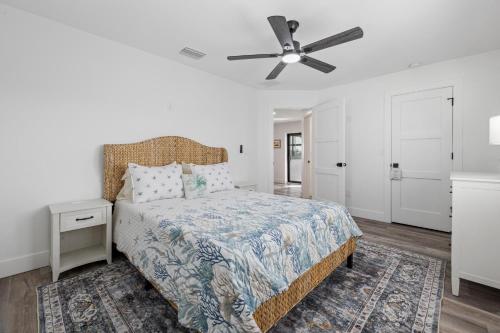 a bedroom with a bed and a ceiling fan at Club Red in Sanibel