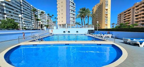 a large swimming pool in a building with tall buildings at Apartment Oceana - Luxury Sea View Beach Apartment in Calpe