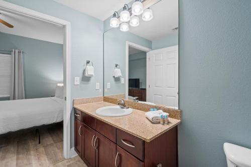 a bathroom with a sink and a large mirror at Laketown Wharf 135 in Panama City Beach