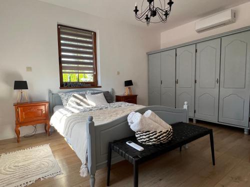 a bedroom with a bed and a table and a window at Dom Na Wsi in Mierzwin Duży