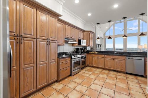 a large kitchen with wooden cabinets and appliances at Chiltren By The Sea in Edisto Island