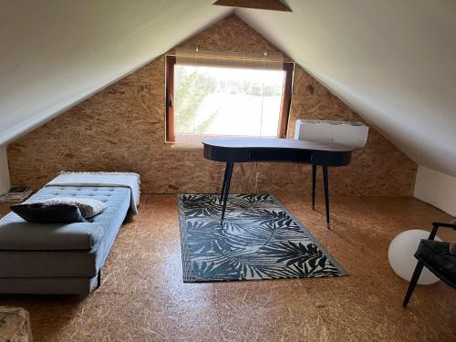 a living room with a table and a couch at Dom Na Wsi in Mierzwin Duży
