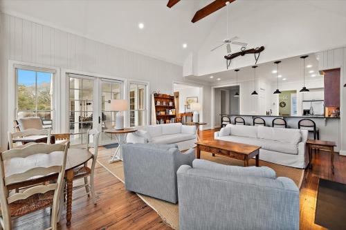 a living room with couches and a dining room at Chiltren By The Sea in Edisto Island