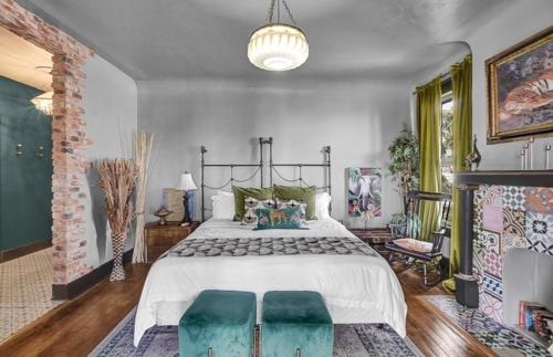 a bedroom with a large bed and a fireplace at Stylish Casa Mina Downtown Free Parking in El Paso