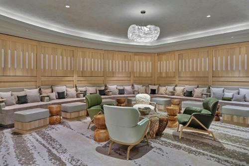 a large room with a waiting room with chairs and tables at St. Regis Aspen Resort in Aspen