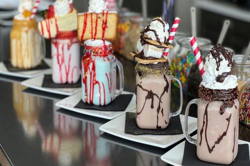 a group of milkshakes in mason jars on a table at SpringHill Suites by Marriott Navarre Beach in Navarre