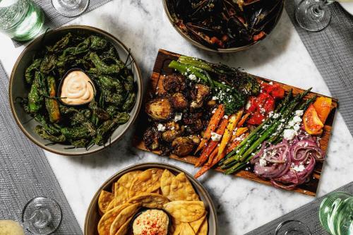 a table topped with bowls of different types of food at SpringHill Suites by Marriott Navarre Beach in Navarre