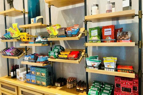 a store shelf filled with food and other food items at The Clancy, Autograph Collection in San Francisco