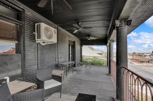 a porch of a house with a fan and chairs at Stylish Casa Mina Downtown Free Parking in El Paso