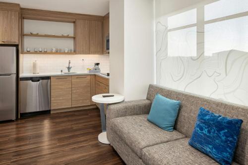 a living room with a couch and a kitchen at Element Minneapolis Downtown North Loop in Minneapolis