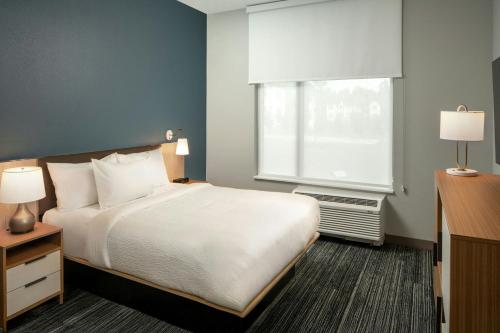 a hotel room with a bed and a window at TownePlace Suites by Marriott West Lafayette in West Lafayette