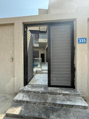a building with a garage door on the side of it at شالية موج 335 in Dhahran