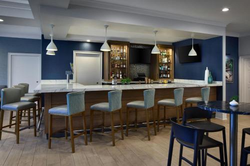 a bar in a restaurant with blue walls and chairs at Residence Inn by Marriott Raleigh Crabtree Valley in Raleigh