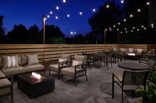 a patio with tables and chairs and lights at night at Residence Inn by Marriott Raleigh Crabtree Valley in Raleigh
