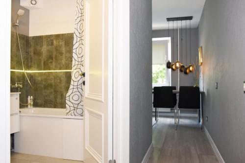 a hallway with a white door and a dining room at LOCUSDO Apartment No.31 in Mažeikiai