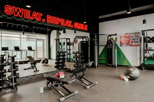a gym with several exercise equipment in a room at Moxy Charlotte Downtown in Charlotte