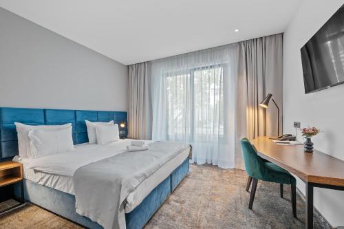 a hotel room with a bed and a desk and a computer at iNova in Zagreb
