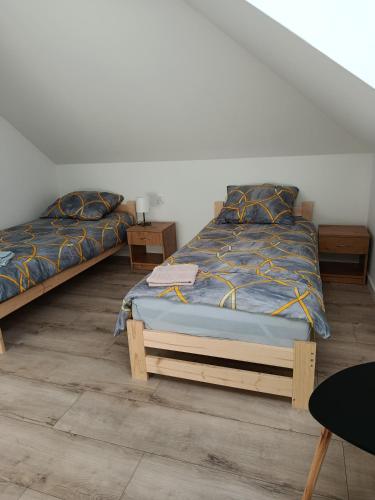 two twin beds in a room with at Noclegi Sarzyna 183 staroniowska in Nowa Sarzyna