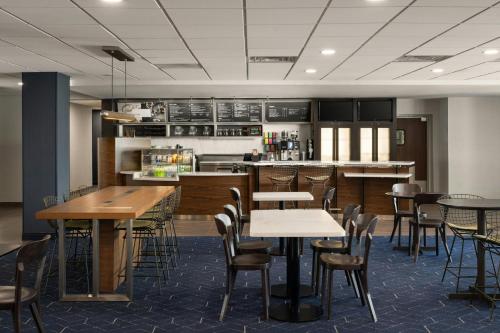 a restaurant with tables and chairs and a kitchen at Courtyard Brunswick in Brunswick