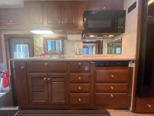 a kitchen with a sink and a microwave at The Great Escape - Shirley & Bunkhouse in Sooke