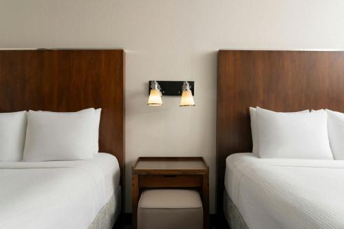 a hotel room with two beds and a table between them at Fairfield Inn & Suites by Marriott Chattanooga in Chattanooga
