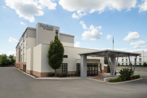 a large white building with a canopy in a parking lot at Fairfield Inn & Suites by Marriott Chattanooga in Chattanooga