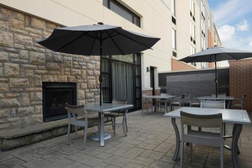 a patio with tables and chairs with umbrellas at Fairfield Inn & Suites by Marriott Chattanooga in Chattanooga