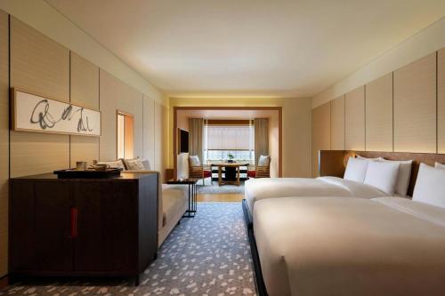 a hotel room with two beds and a desk at The Ritz-Carlton Kyoto in Kyoto