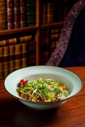 a bowl of salad sitting on a table at Maxwell Reserve Singapore, Autograph Collection in Singapore