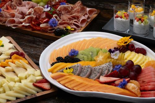 a table with a plate of different types of food at Nekajui, a Ritz-Carlton Reserve Residences in Liberia
