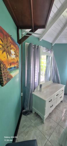 a bedroom with a bed and a painting on the wall at Casa Mariner Resort in Good Hope