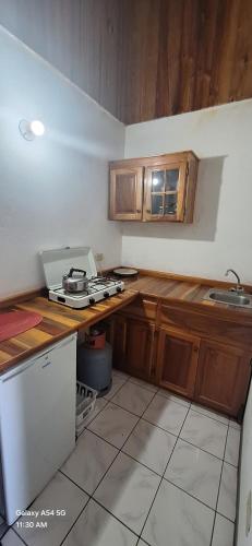 a kitchen with wooden cabinets and a counter top at Casa Mariner Resort in Good Hope