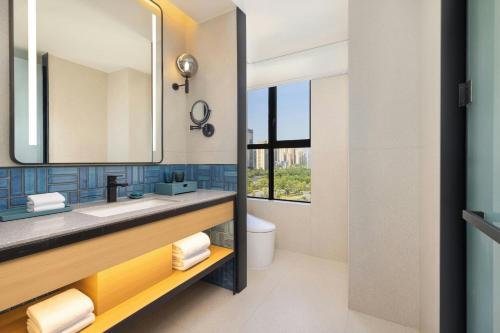 a bathroom with a sink and a mirror at Four Points by Sheraton Ji’an in Ji'an