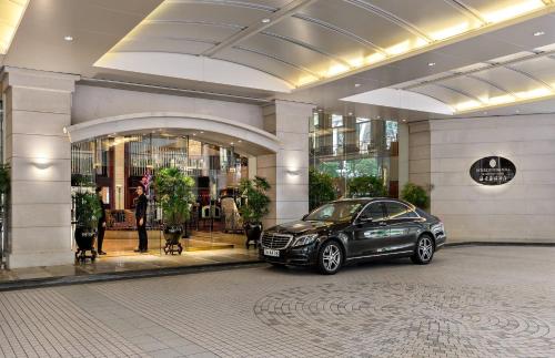 a car parked in front of a building at InterContinental Grand Stanford Hong Kong by IHG in Hong Kong