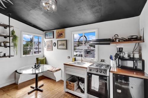 a kitchen with a stove and a sink and a table at Historic Casa Mina 1br Near Downtown W Parking in El Paso