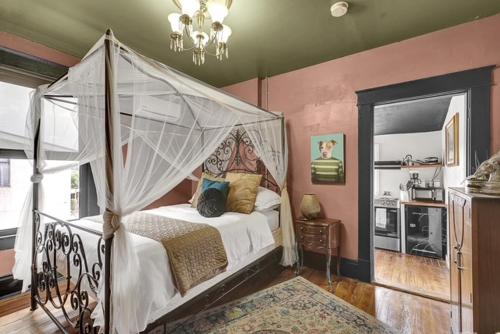 a bedroom with a bed with a canopy at Historic Casa Mina 1BR Near Downtown w Parking in El Paso