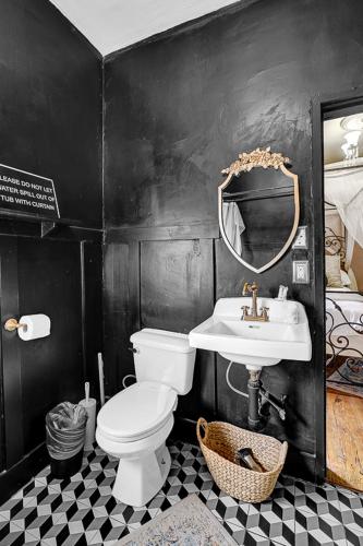 a bathroom with a white toilet and a sink at Historic Casa Mina 1BR Near Downtown w Parking in El Paso