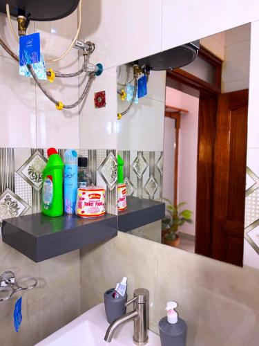 a bathroom with a sink and a mirror at Munyonyo Haven in Kampala