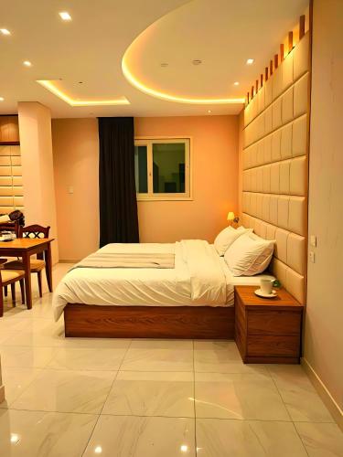a bedroom with a large bed and a table at Pyramids Grand View Hotel in Cairo