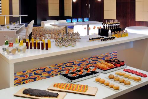 a buffet with many different types of food on display at Marriott Marquis City Center Doha Hotel in Doha