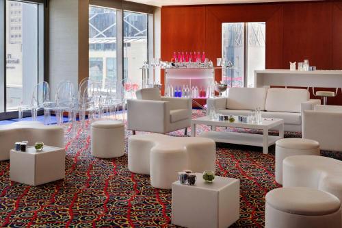 a lobby with white furniture and tables and windows at Marriott Marquis City Center Doha Hotel in Doha
