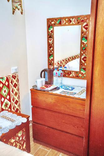 a dressing room with a mirror and a dresser at Five Pyramids Peaks View in Cairo