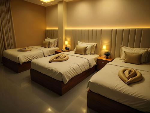 a bedroom with two beds with towels on them at Pyramids Grand View Hotel in Cairo
