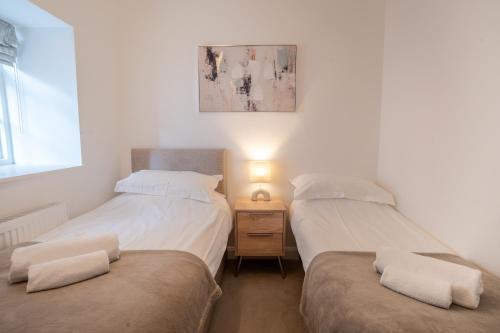 Postel nebo postele na pokoji v ubytování Lonsdale House Boutique Apartments