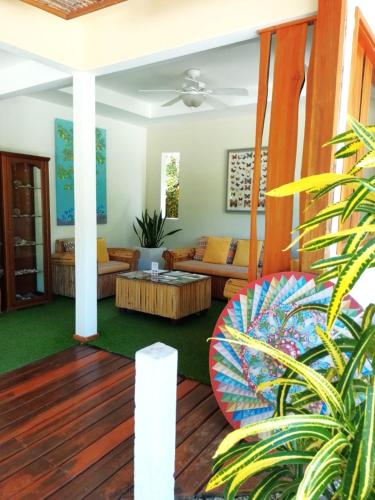 a living room with a couch and a table at Montelaguna Boutique Hotel in Sámara