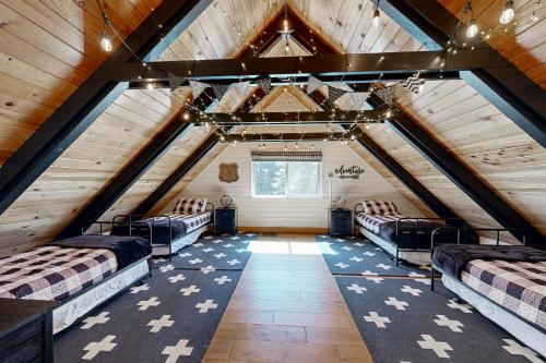 a room with four beds in a attic at Hot Tub, Game Room & Home Gym: Serene Arnold Gem in Arnold