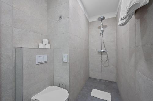 a bathroom with a toilet and a shower at iNova in Zagreb