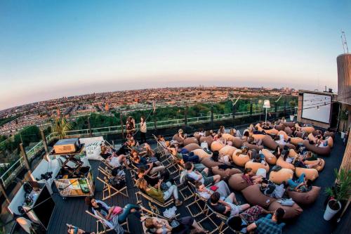 a crowd of people sitting on the roof of a building at Leonardo Hotel Amsterdam Rembrandtpark in Amsterdam
