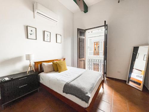a bedroom with a large bed and a window at Old San Juan Rentals in San Juan