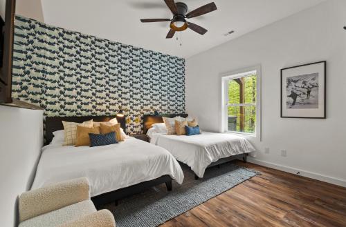 a bedroom with two beds and a ceiling fan at New The Chaletresorthot Tubgameroomfirepit in Massanutten